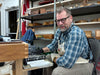 Man working at a desk in a workshop setting