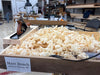Wooden box filled with popcorn in a workshop setting