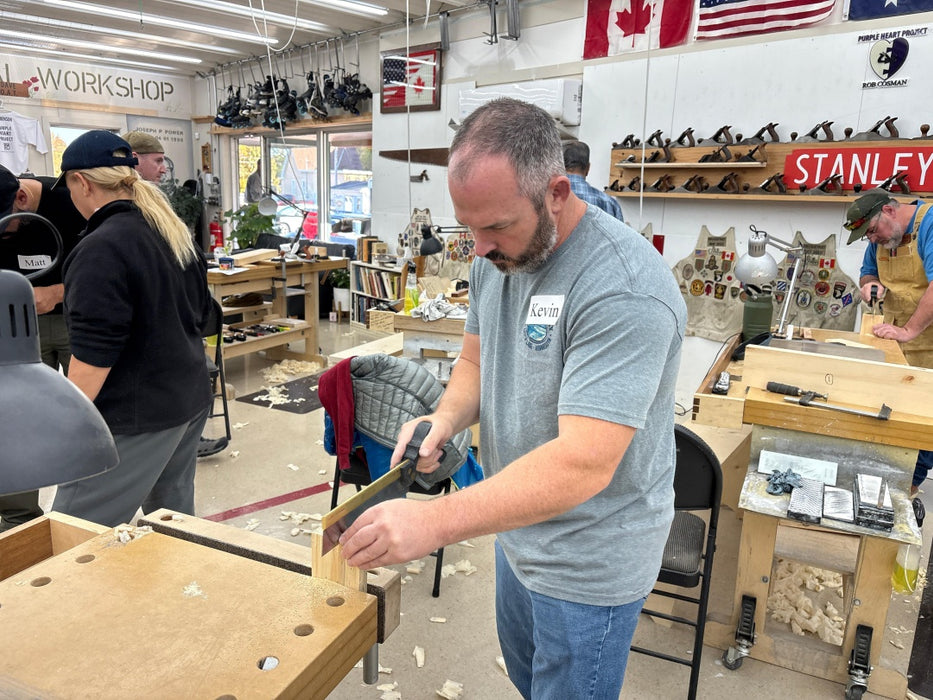 Man working in a workshop with tools and equipment around