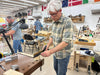 Man working in a workshop with tools and equipment around