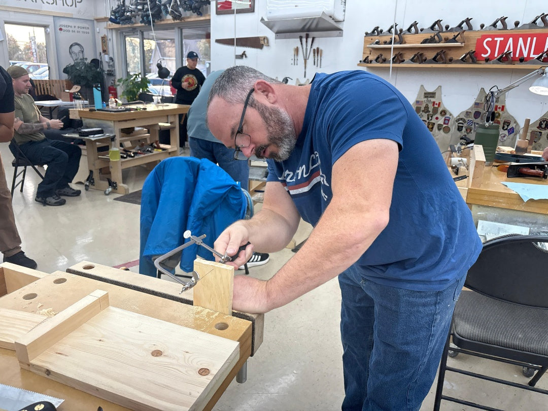 Man working on a wooden project in a workshop setting