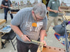 Man working on a project in a workshop with tools and materials around