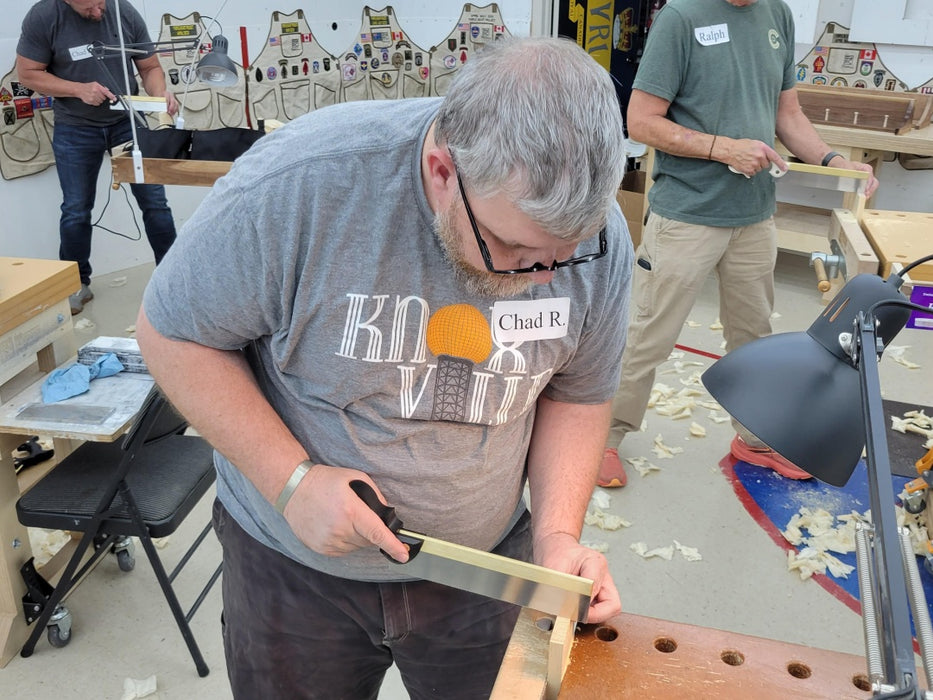 Man working on a project in a workshop with tools and materials around
