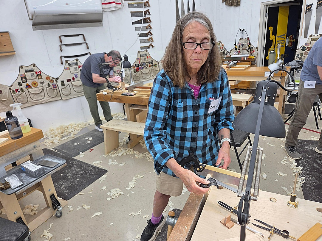 Person working in a workshop with tools and materials around