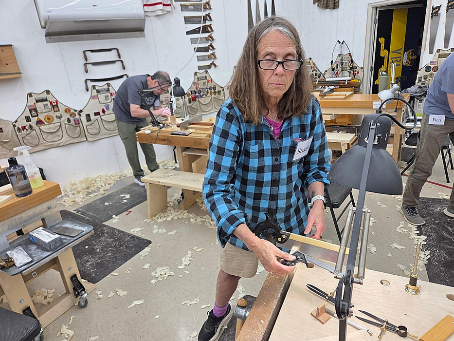 Person working in a workshop with tools and materials around
