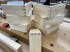 Stack of wooden boxes with dovetail joints on a workshop bench.