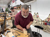 Man working in a workshop with tools and equipment around