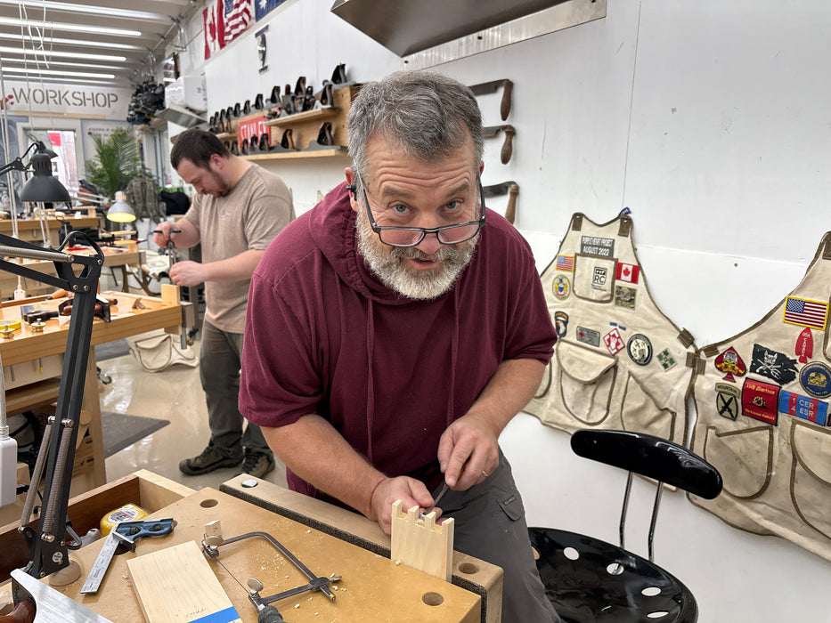 Man working in a workshop with tools and equipment around