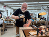 Man working with wood in a workshop setting