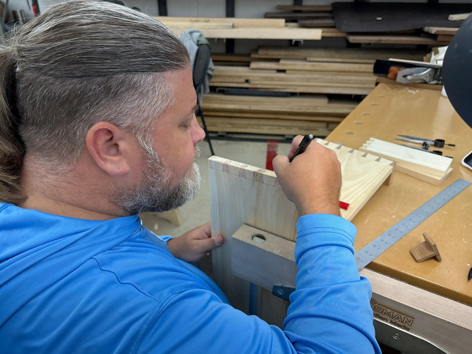 Person working on a wooden project in a workshop