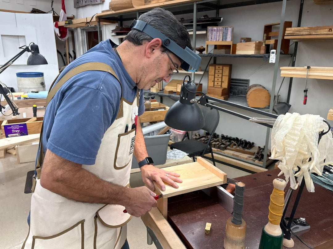 Man working on a wooden project in a workshop