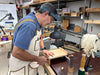 Man working on a wooden project in a workshop