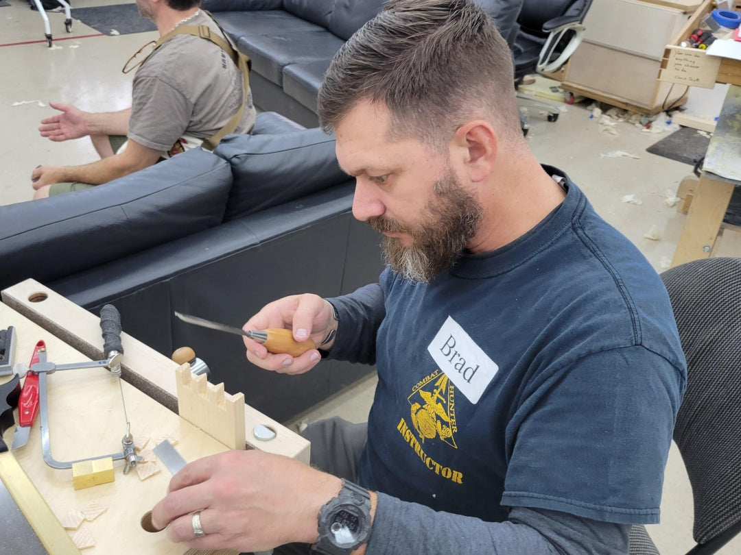 Man working on a project with tools in an indoor setting