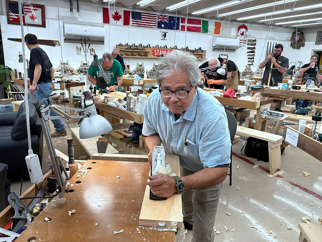 Man working on a project in a workshop with various tools and equipment around.