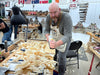 Man working in a workshop with tools and materials around