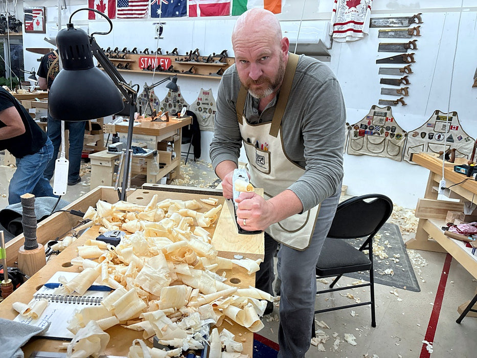 Man working in a workshop with tools and materials around