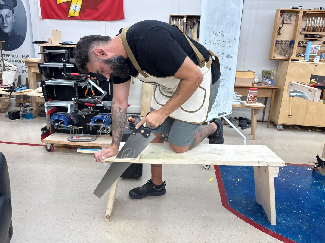 Man using a table saw in a workshop setting