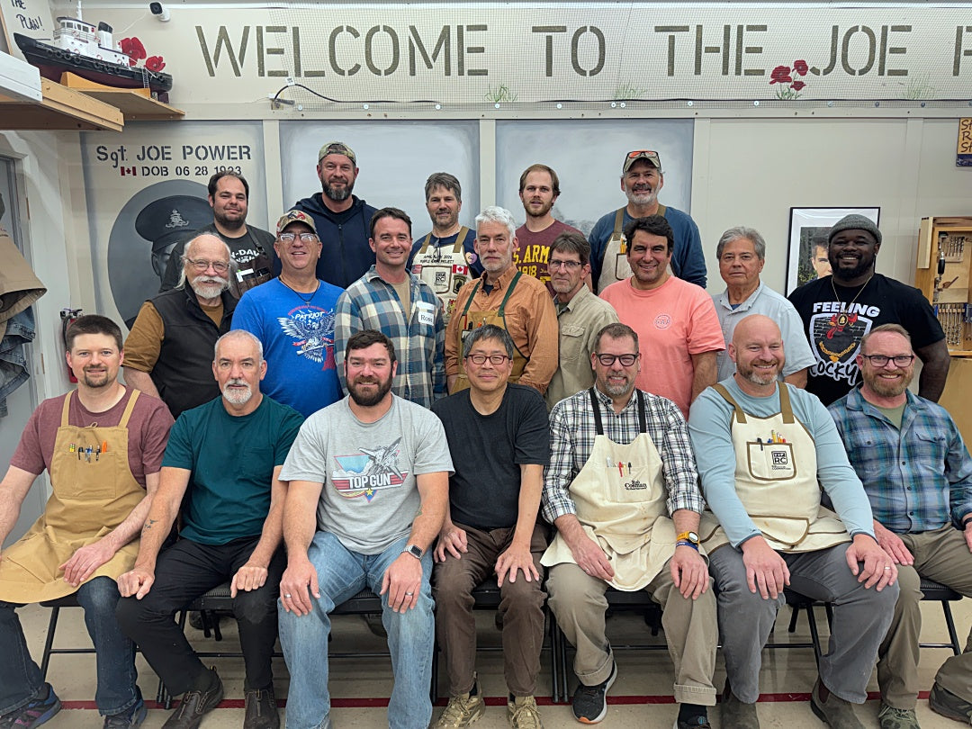 Group of people posing for a photo in front of a 'Welcome to the Joe' sign.