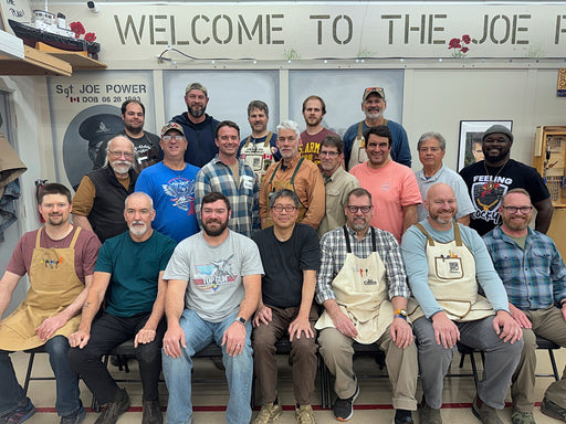 Group of people posing for a photo in front of a 'Welcome to the Joe' sign.