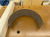 An unfinished hard maple vise jaw with a sheet of self- adhesive cork rubber material on a workbench.