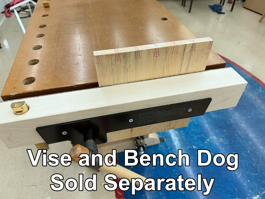 A close-up of a woodworking bench vise with a hard maple vise jaw holding a piec of pine.  Large white text at the bottom reads 'Vise and Bench Dog Sold Separately'.