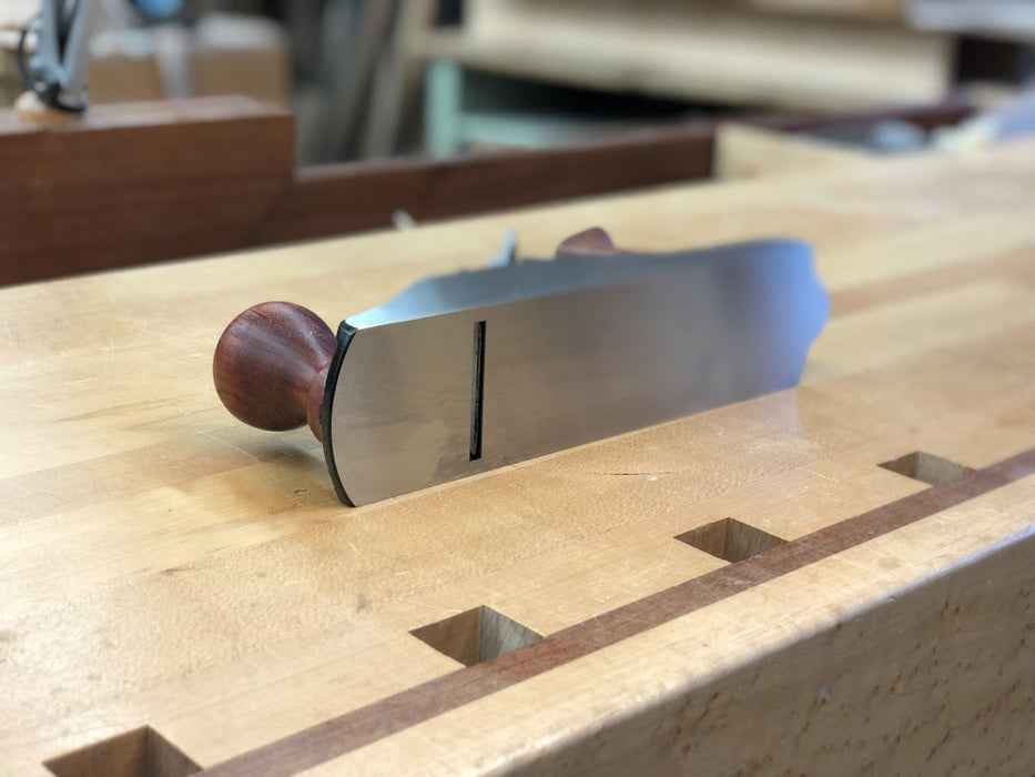 Woodworking tool on a wooden surface with blurred background