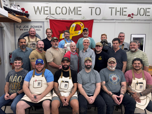 Group of men posing for a photo in front of a 'Welcome to The Joe' sign.