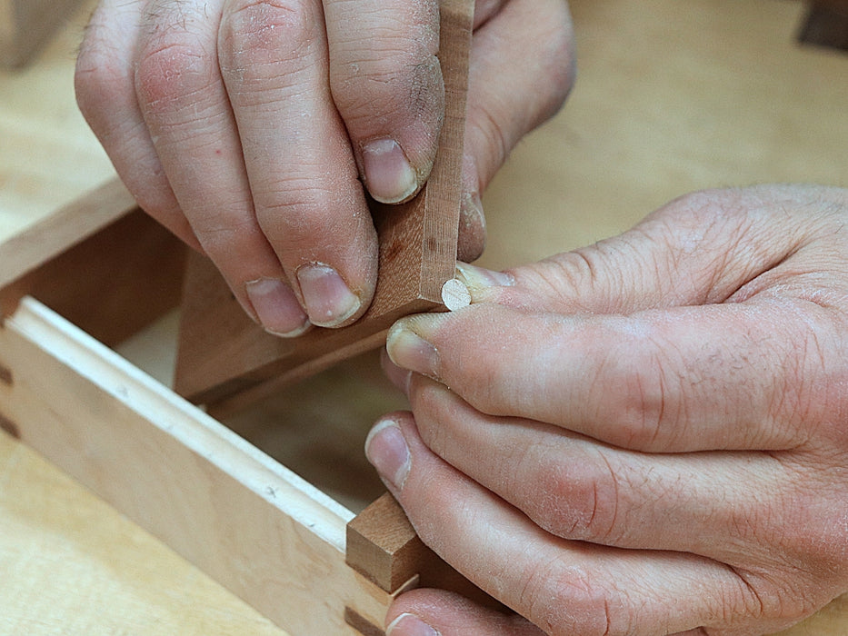 Rob Cosman fitting the dowel into the grove he just cut for his woodhinge