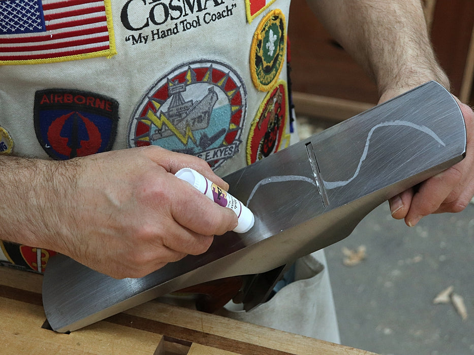 Rob demonstrating applying wax to the bottom of a plane