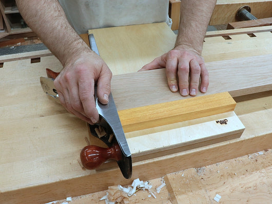 Rob Cosman using a shooting board to square the end of a piece of stock