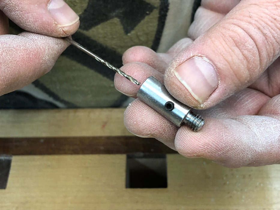 Inserting drill bit into Rob Cosman's wood-hinge drill jig