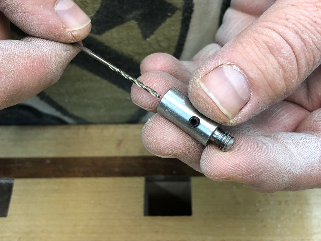 Inserting drill bit into Rob Cosman's wood-hinge drill jig