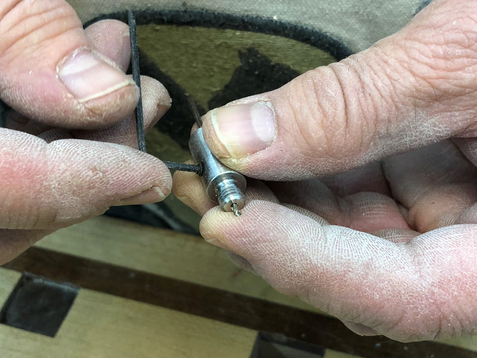 Tightening the set screw that locks in the drill bit in the wood-hinge drill jig